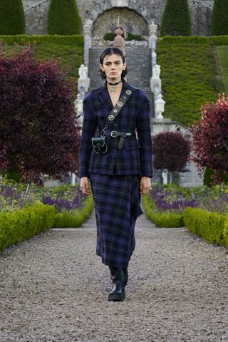 Dior runway show featuring model in tartan outfit