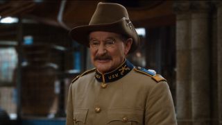 Robin Williams stands smiling in the museum loading dock in Night At The Museum: Secret of the Tomb.