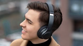 Man wearing Anker Soundcore Life Q20.