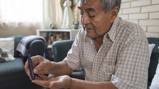 A man with diabetes tests his blood sugar with a finger prick.