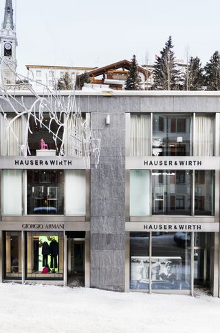 Three-storey building with top to ceiling glass window panels with silver steel detail. Photgraphed during the day after the snow