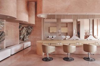 Swivel chairs, wood counter and mirrors at the Pressed Roots hair salon in Texas