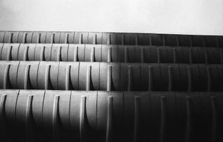 A black & white photo of a curved long structure that's repeated four times.