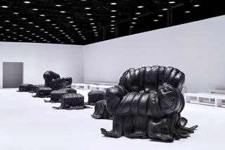 Acne Studios A/W 2024 show set with Villu Jaanisoo’s rubber tire sofas