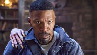 JAMIE FOXX as BUD JABLONSKI, with a vampire&#039;s hand on his shoulder, in Day Shift.