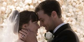 fifty Shades Jamie Dornan and Dakota Johnson laughing during wedding scene.