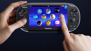 P;ayStation Vita being held by left hand, right hand is using the touchscreen