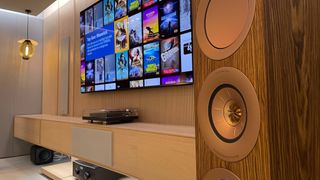 KEF R11 Meta speakers in a room next to a flatscreen TV