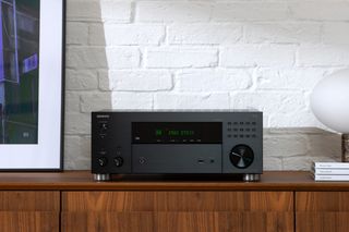 ONKYO TX-RZ30 AV receiver in black on a sideboard