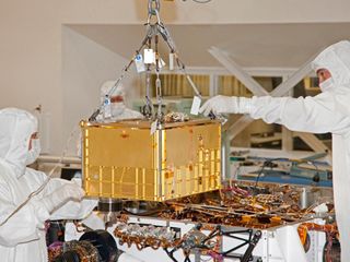 Technicians and engineers carefully install the 88-pound (40-kilogram) SAM instrument on the Curiosity rover. The picture was taken at NASA's Jet Propulsion Laboratory, Pasadena, Calif., on Jan. 6, 2011.