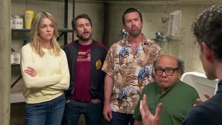 Dee (Kaitlin Olson), Charlie (Charlie Day), Mac (Rob McElhenney) and Frank (Danny DeVito) looking at Dennis (Glenn Howerton) almost off camera in a still from It&#039;s Always Sunny In Philadelphia season 15