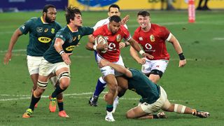 British &amp; Irish Lions vs South Africa live stream — Anthony Watson of the British &amp; Irish Lions is tackled by Damian de Allende and Franco Mostert during the 1st Test