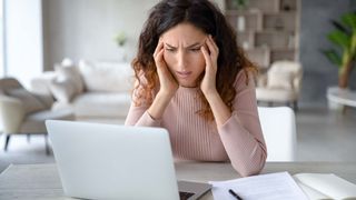 A woman looking frustratingly at her computer