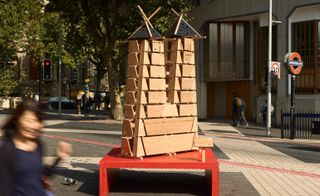 Wooden signpost on red plinth