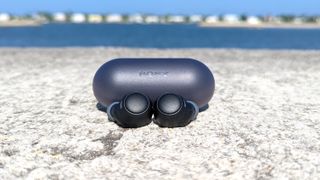 Listing image for best cheap wireless earbuds showing the Sony WF-C500 displayed on a concrete surface