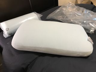 Two Casper Hybrid Pillows with Snow Technology, one wrapped in its shrink wrap, the other fully expanded