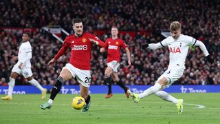 Tottenham's Timo Werner shoots as Man Utd's Diogo Dalot tries to incercept during the sides' January 2024 Premier League encounter.