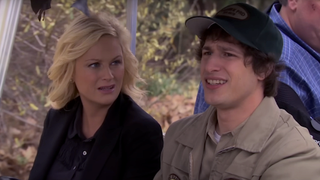 Andy Samberg and Amy Poehler riding in a golf cart in Parks and Recreation