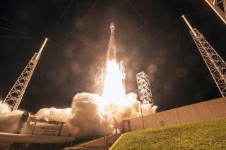 An Atlas V 421 rocket launches at night