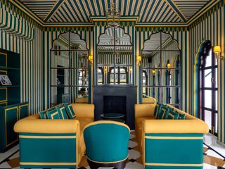 A lounge room boasting a turquoise and yellow sofa