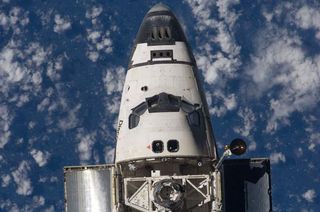 An overhead close-up view of the exterior of shuttle Discovery's crew cabin, part of its payload bay and docking system was provided by Expedition 18 crewmembers on the International Space Station on March 17, 2009 during the STS-119 mission.