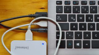 close up of external hard drive and laptop