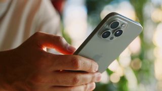 A man typing on an iPhone