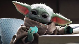 Baby Yoda eating a cookie in The Mandalorian