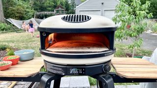 Gozney Arc pizza oven shown outside in a backyard