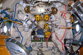 Two Russian Orlan spacesuits sit empty on the International Space Station ahead of a spacewalk in 2014. Space Adventures and Roscosmos have booked a private spacewalk for one of two space tourists flying to the station in 2023.