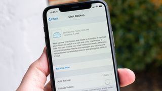 WhatsApp on iPhone with chat backup options on screen