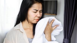 Woman smelling a white towel