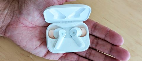 The Donner DoBuds One wireless earbuds held in reviewer&#039;s hand