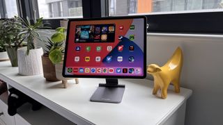 Lululook Foldable Magnetic iPad Stand on a bedside table with iPad Pro