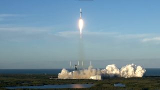 a white rocket flies through the air in a perfectly blue sky