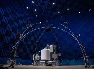 the toilet takes center stage under an archway of sensors and scientific equipment designed to test the toilet prior to launch.