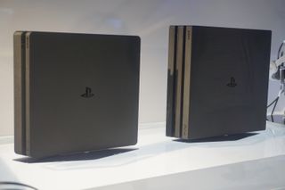 The PS4 Slim and the PS4 Pro, stood next to each other vertically in a display