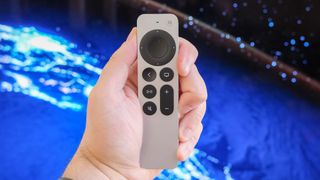 The Apple TV 4K (2022) remote in hand.