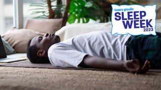 Man lying on his back on a yoga mat, eyes closed