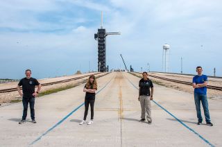 Chris Sembroski, Hayley Arceneaux, Sian Proctor and Jared Isaacman pose in front of their SpaceX launch pad, Complex 39A at NASA's Kennedy Space Center in Florida on Monday, March 29, 2021.