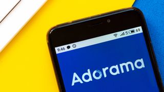A smartphone with the Adorama logo on its screen