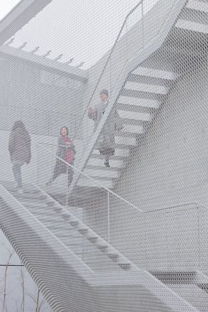 The gallery has stairs that meander in and out of the building