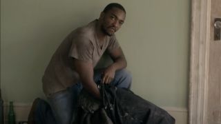 Marcus (Anthony Mackie) packing belongings in Night Catches Us