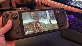 Photo of Steam Deck handheld console playing God of War