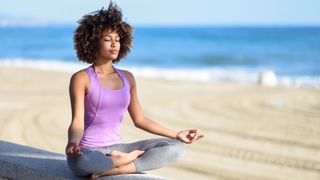 A woman practices deep breathing to relax herself