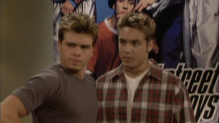 Matthew Lawrence as Jack and Will Friedle as Eric standing in front of a Backstreet Boys poster on Boy Meets World