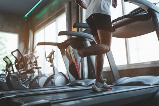 Close up of feet, sportman runner running on treadmill in fitness club for Horizon Fitness Coupon codes