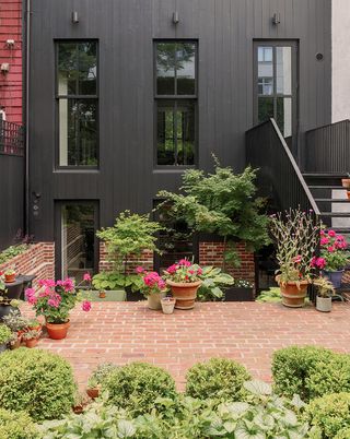 exterior with planting of house Stick House, Brick Garden