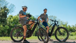 Two men on MOD electric bikes outside