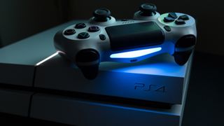 PS4 console with controller in dim lighting